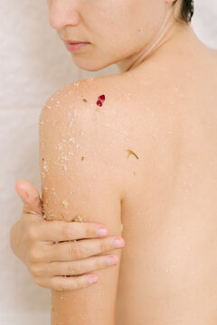 Woman apply cosmetic product to body in bathroom