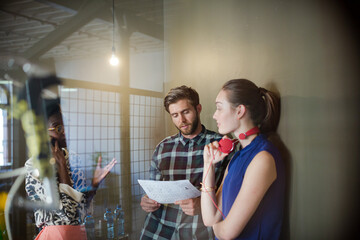 Creative business people working behind bicycle wheel in office