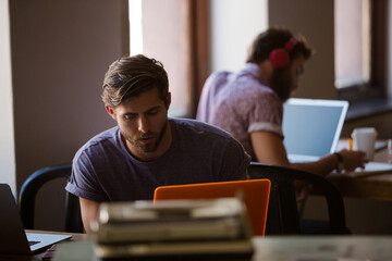 Fototapeta premium Casual business people using laptop in office