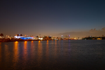 Fototapeta premium City of Miami Florida, sunset panorama with business and residential buildings and bridge on Biscayne Bay. Skyline night view.