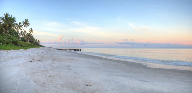 Sunrise over old pier on the ocean at Port Royal Beach