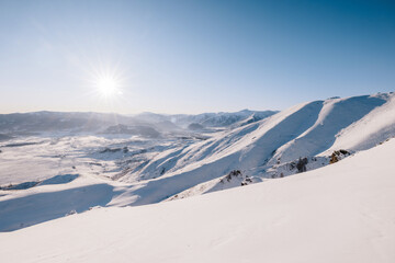 Snow mountains with sun