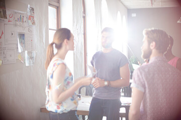 Casual business people meeting in circle in sunny office