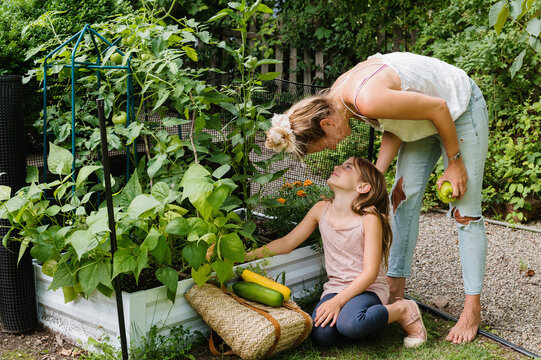 Mother Bonding with Daughter at Vegetable Garden