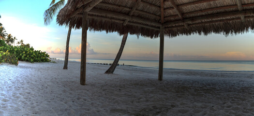 Sunrise over tiki hut on the ocean at Port Royal Beach