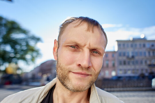 Serious Caucasian male in his 40s with early receding hairline.