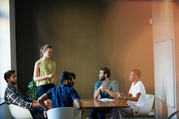Casual business people meeting at table in office
