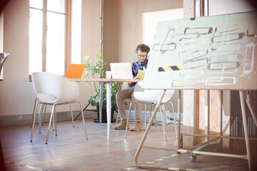 Casual businessmen using laptop in office