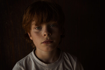 Redhead, freckled boy outdoors