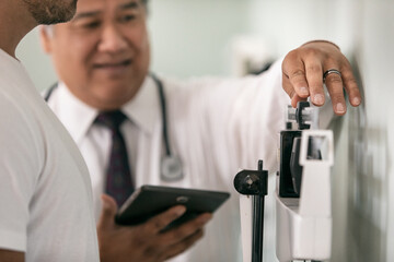 Exam: Doctor Adjusts Weights On Scale