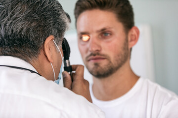 Exam: Doctor Uses Ophthalmoscope During Vision Test