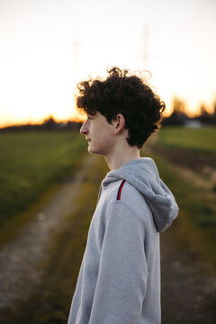 Thoughtful profile portrait of teenager outside