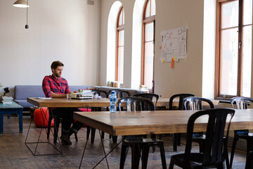 Portrait smiling creative writer at typewriter in office