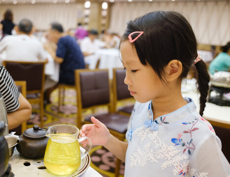 little girl making tea drink