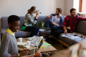 Creative business people playfully posing for coworker instant camera