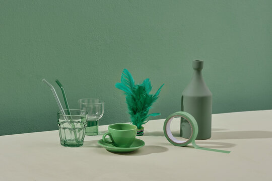 Still life with glassware on green table