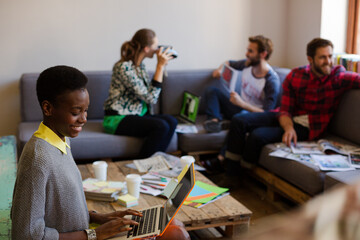 Creative business people playfully posing for coworker instant camera