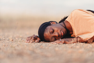 Black woman asleep on the sand
