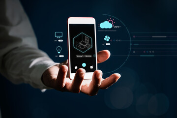 Businessman holding smart phone with virtual screen of smart home automation application. Smart home controlling and Automation system technology of things