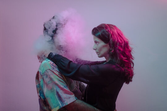 Young woman dancing with a smoke head