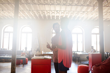 Smiling casual business people working at computer in office