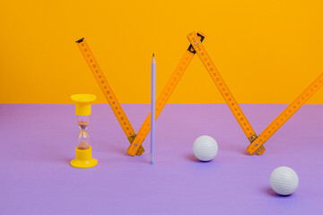 Ruler, hourglass, pencil and golf balls