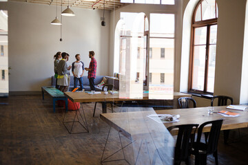 Creative business people talking in circle in office