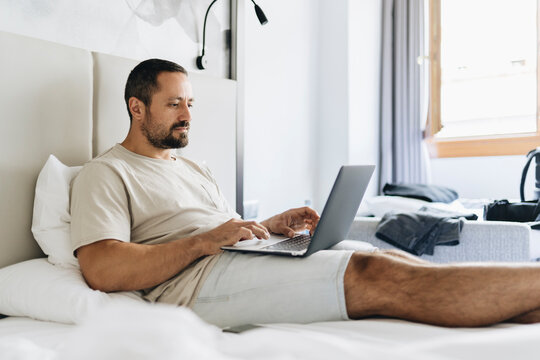 A man working from bed