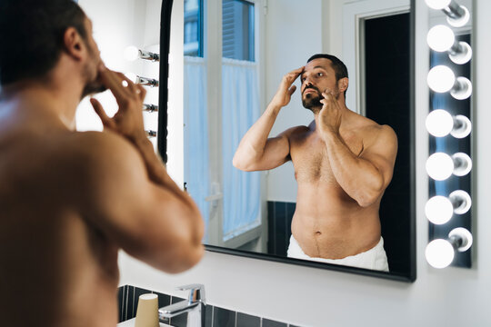 A man in a bathroom mirror