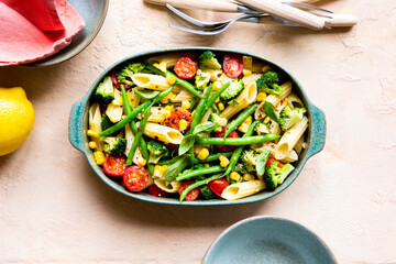 Pasta primavera with broccoli, green beans, corn, vegetables and cherry tomato