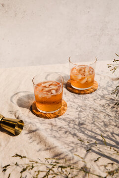 Pair of iced drinks in the sun casting shadows 