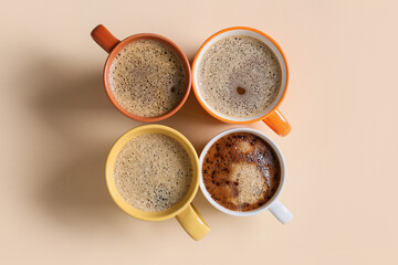 Cups of tasty coffee on light background