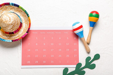 Mexican maracas, calendar with marked date 5 May (Cinco de Mayo) and sombrero on white background