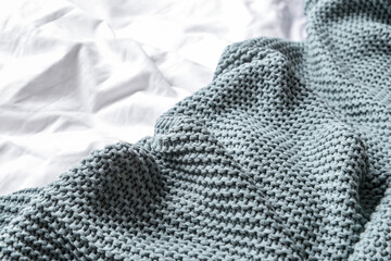 Knitted plaid on bed, closeup - obrazy, fototapety, plakaty