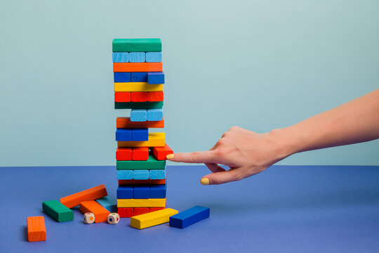 Tower of colorful blocks on blue paper background 