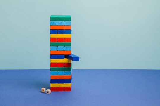 Tower of colorful blocks on blue paper background