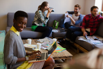 Creative business people playfully posing for coworker instant camera