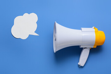 Modern megaphone and speech bubble on color background