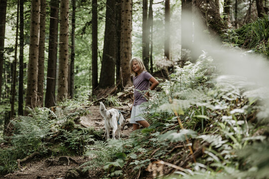 boy and dog in beautiful forest