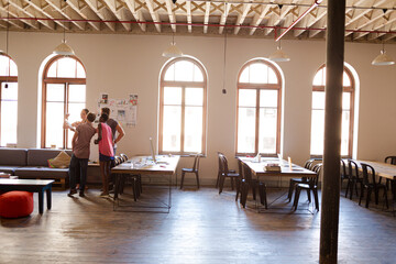 Creative business people talking in circle in office