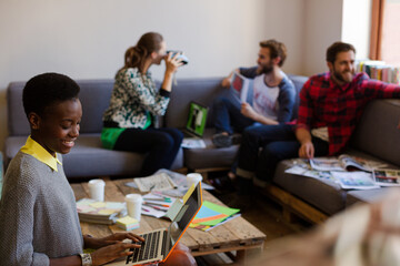 Creative business people playfully posing for coworker instant camera