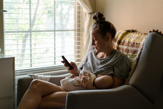 Multitasking Mother Breastfeeding