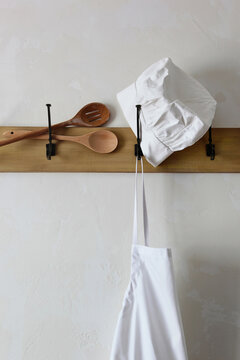  Cooking utensils and apron on hooks