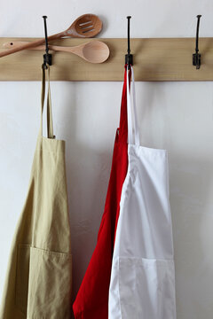  Aprons and wooden utensils on hooks