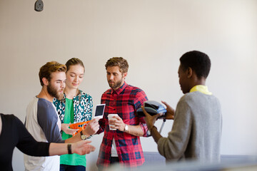 Creative business people looking at instant photo
