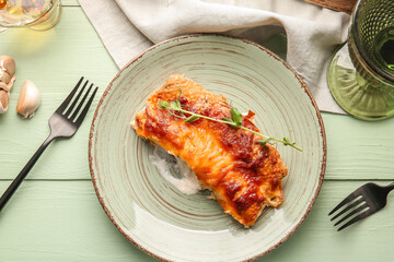 Plate with piece of delicious casserole with minced meat on color wooden table