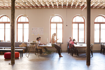 Casual business people talking in meeting in office