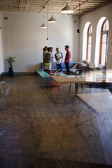 Creative business people talking in circle in office