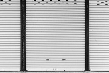 The white roller shutter door of the store is closed