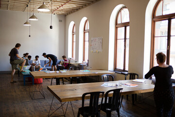 Creative business people talking in circle in office